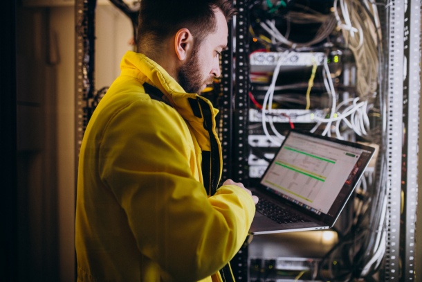 IT professional working next to servers